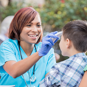 Woman taking boys temperature