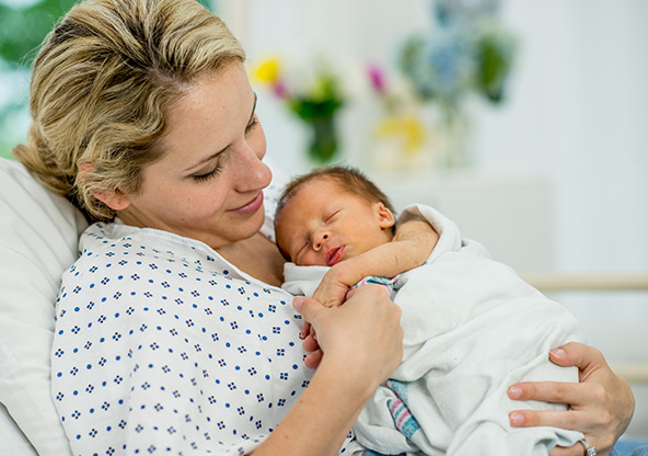 A mom holds her newborn baby